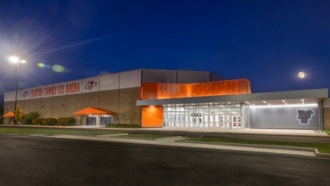 Slater Ice Arena at night with the moon directly behind it.