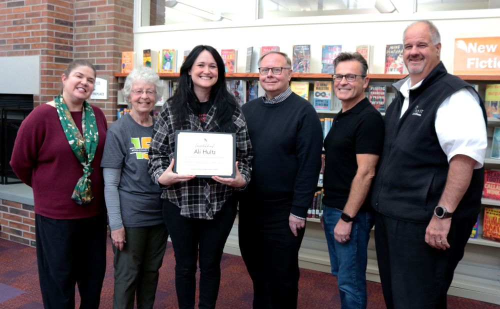 2025 Winner Ali Hultz smiling with the Board of Trustees.