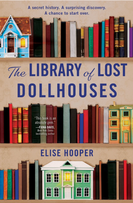 Dollhouses are nestled between books on shelves on the cover of The Library of Lost Dollhouses by Elise Hooper.