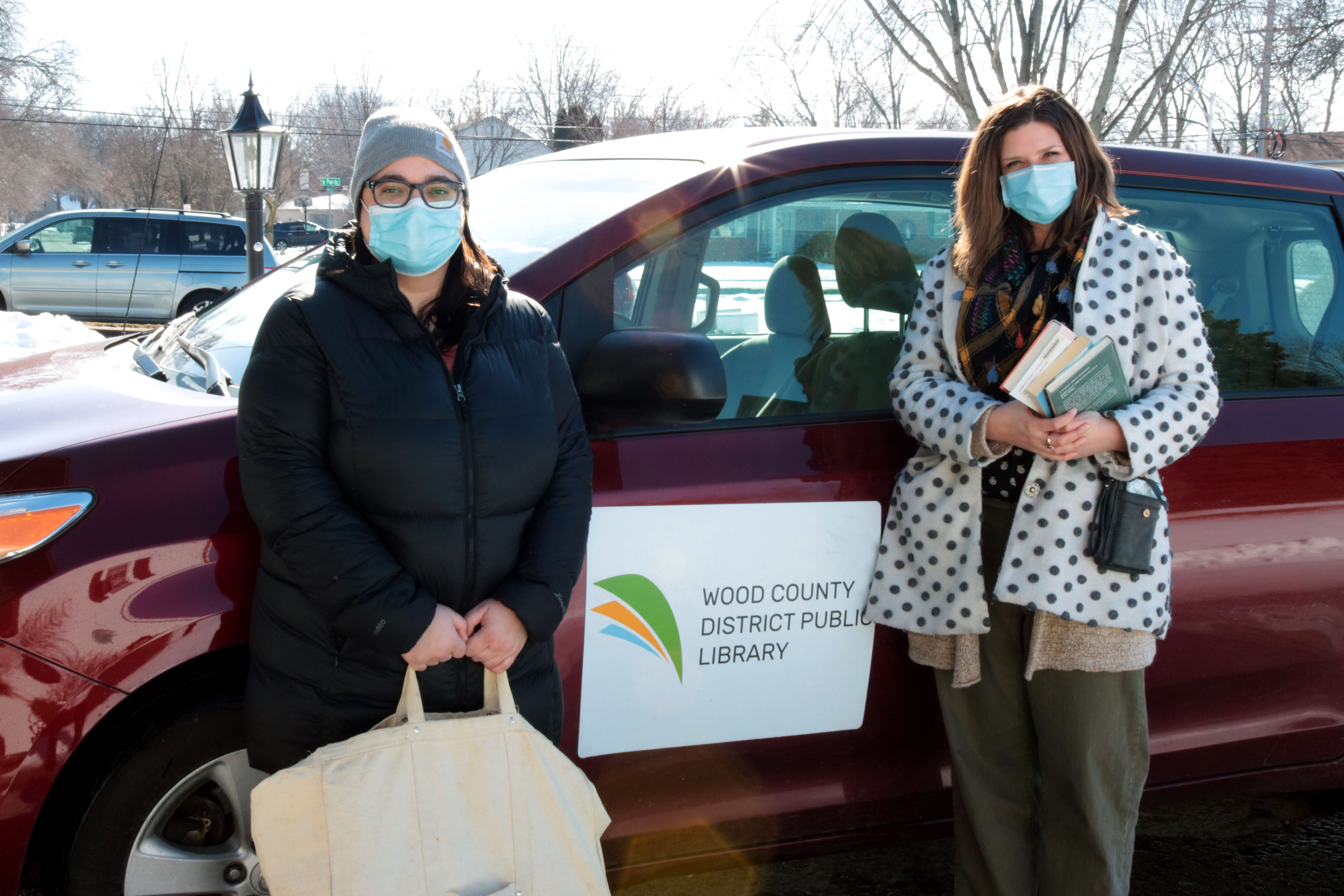 Staff members Lauren and Rachel deliver books and other materials.